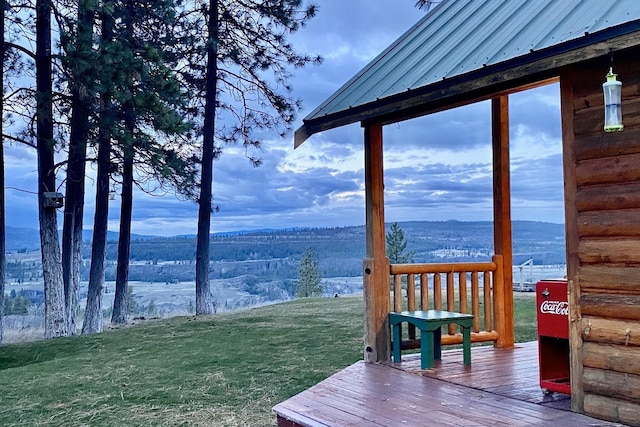 deck featuring a mountain view and a yard