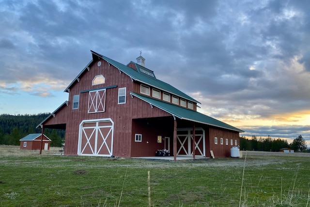 view of barn with a lawn