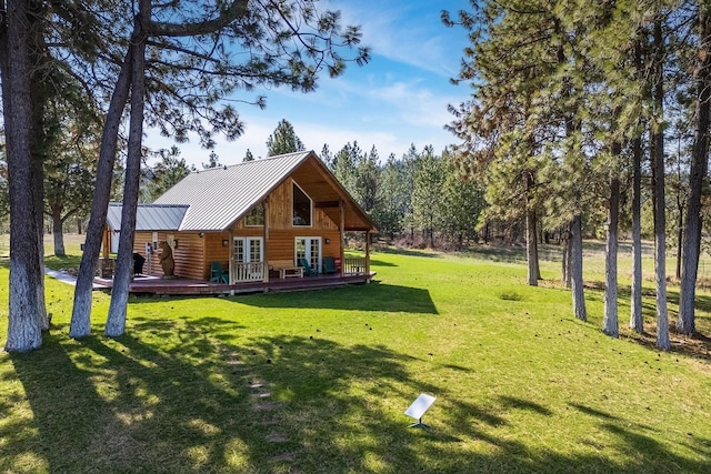 view of yard featuring a deck and french doors