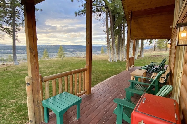 wooden terrace with a lawn and a rural view
