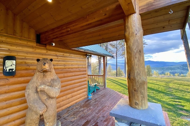 wooden deck with a lawn and a mountain view