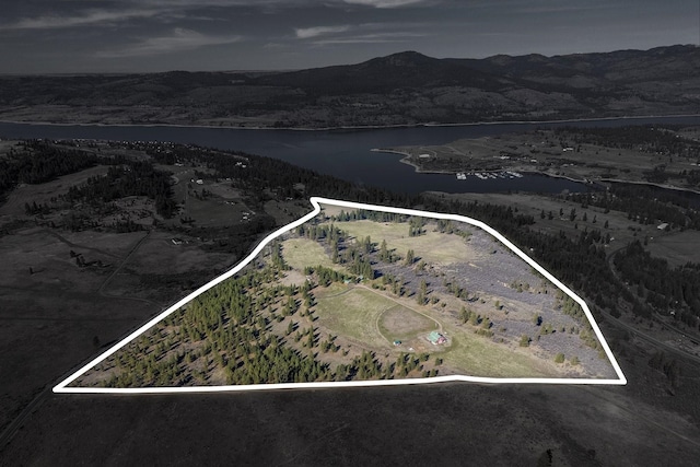birds eye view of property featuring a water and mountain view
