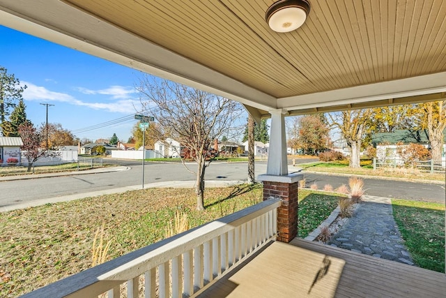 wooden terrace featuring a porch and a residential view