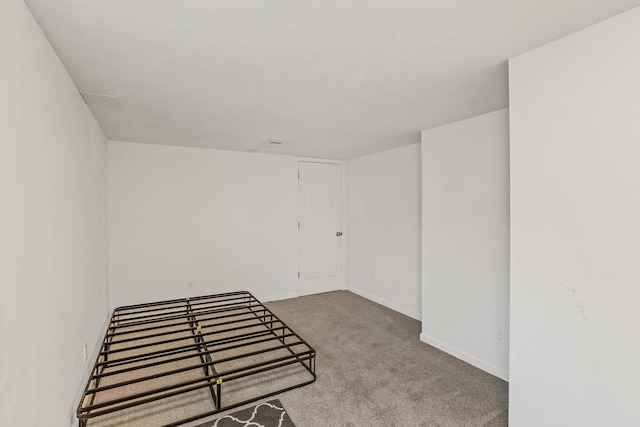 unfurnished room featuring baseboards and carpet floors