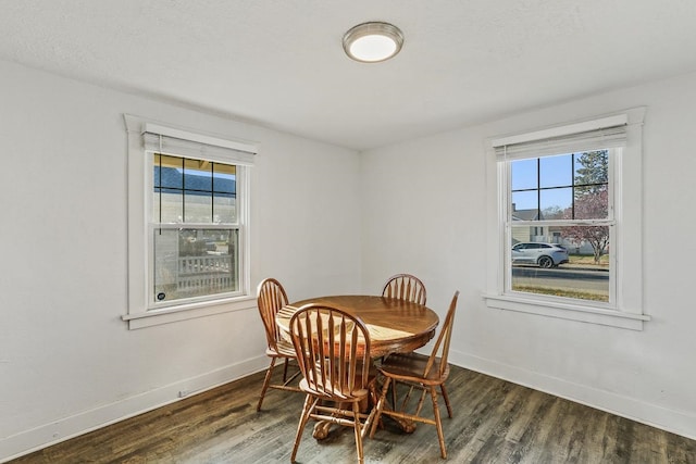 dining area featuring a wealth of natural light, wood finished floors, and baseboards