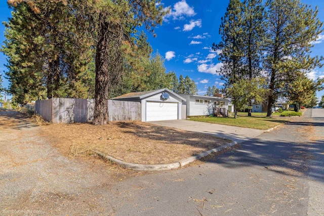 6503 N Calispel St, Spokane, WA 99208 - ranch-style home featuring concrete driveway, a garage, a front lawn, and fence