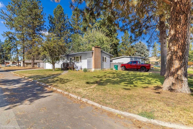 6503 N Calispel St, Spokane, WA 99208 - view of front facade with a chimney and a front yard