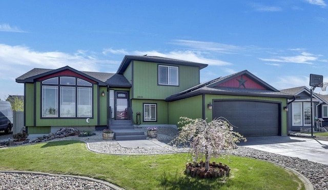 view of front facade featuring a front lawn, driveway, and an attached garage