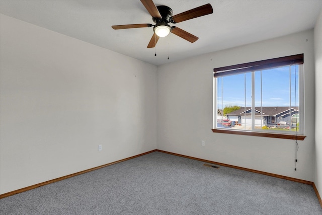 unfurnished room with baseboards, visible vents, and carpet flooring