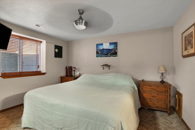 bedroom featuring visible vents, ceiling fan, and baseboards