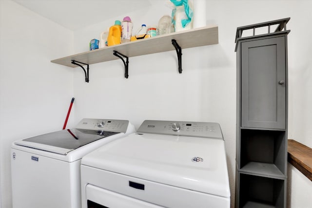 clothes washing area with washer and dryer and laundry area