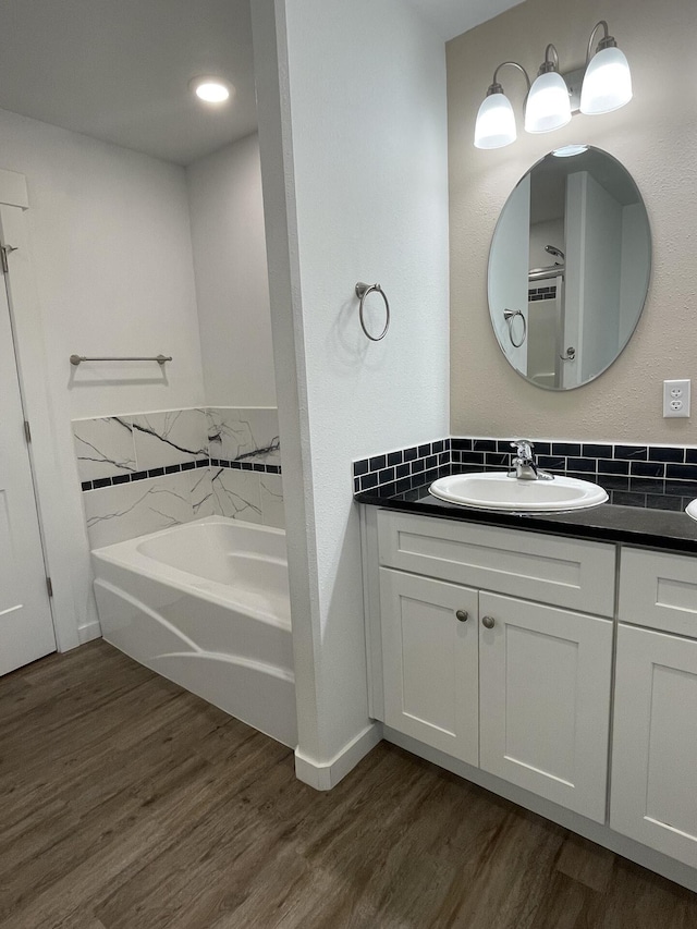 2942 W 18th Ave, Spokane, WA 99224 - full bathroom with wood finished floors, vanity, and a bath