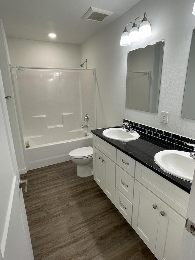 2942 W 18th Ave, Spokane, WA 99224 - bathroom with toilet, a sink, decorative backsplash, and visible vents