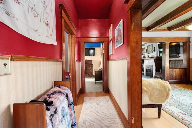 hallway featuring wainscoting and wood finished floors