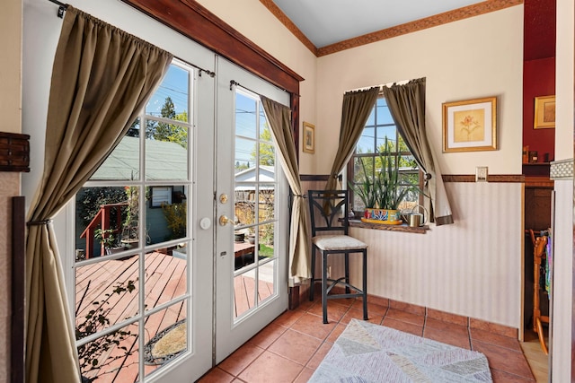 entryway featuring tile patterned floors, wainscoting, and french doors