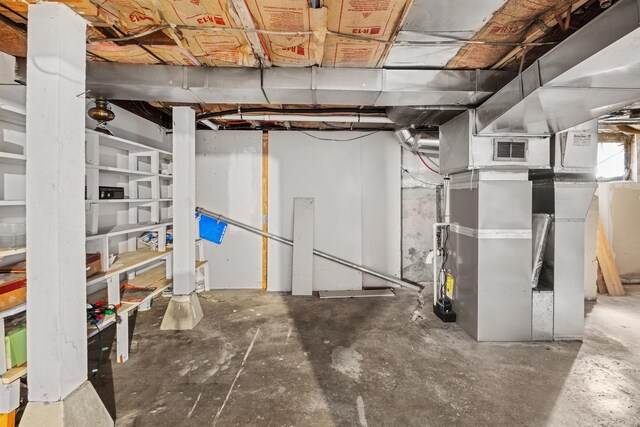unfinished below grade area with visible vents and heating unit