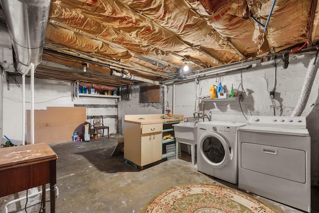 laundry area featuring a sink, washing machine and clothes dryer, and laundry area