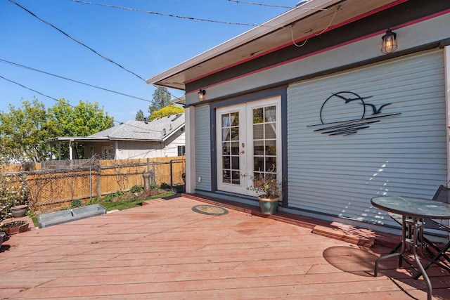 wooden deck featuring french doors and fence