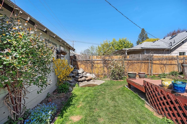 view of yard with a deck and fence
