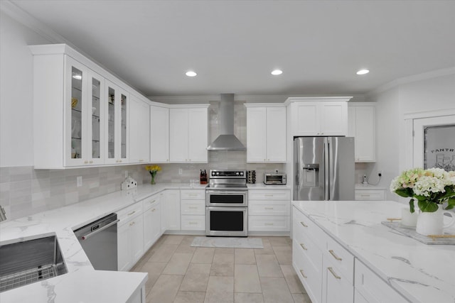 kitchen featuring tasteful backsplash, glass insert cabinets, stainless steel appliances, a sink, and wall chimney exhaust hood