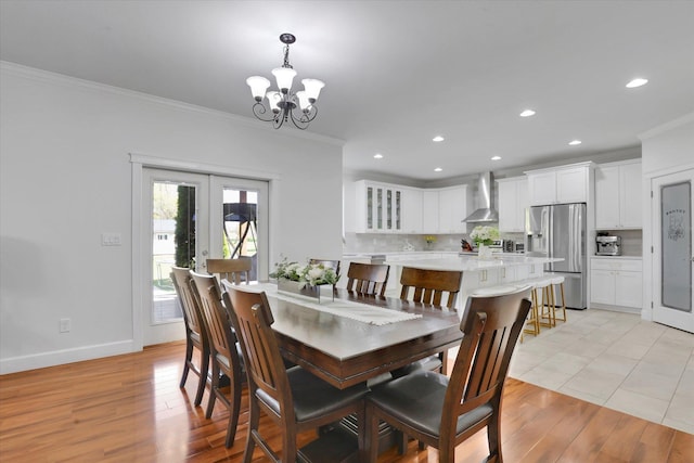 dining space with recessed lighting, a chandelier, light wood-style floors, crown molding, and french doors