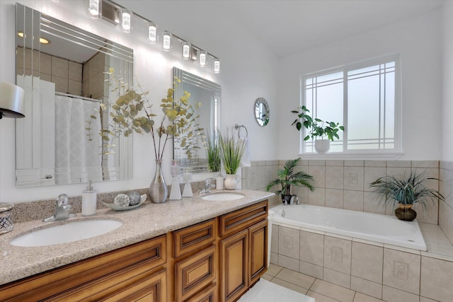 full bath with double vanity, tile patterned flooring, a bath, and a sink