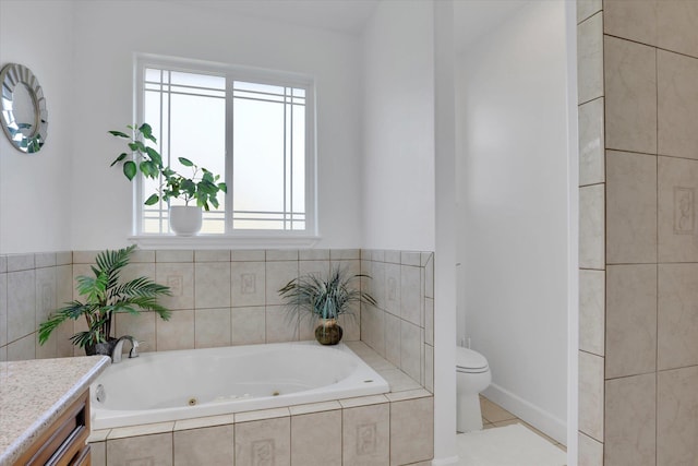 full bathroom with tile patterned floors, toilet, a whirlpool tub, and vanity