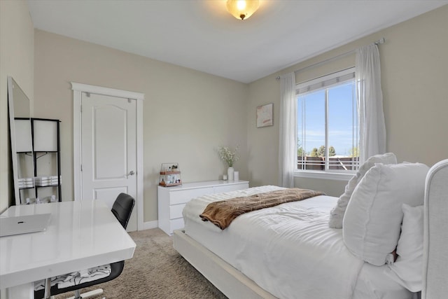 bedroom with light carpet and baseboards