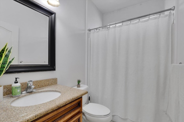 bathroom with toilet, curtained shower, and vanity