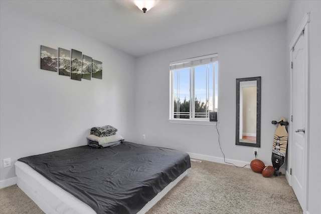 carpeted bedroom featuring baseboards