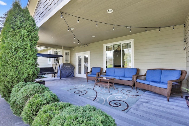 view of patio / terrace with outdoor lounge area, a deck, and french doors