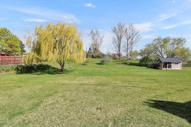 view of yard with an outdoor structure and fence