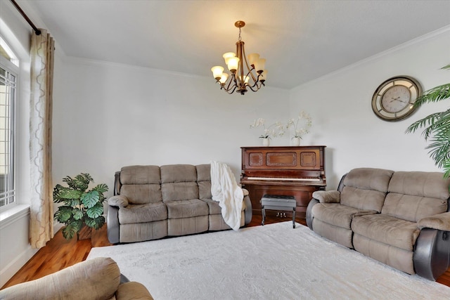 living area with ornamental molding, an inviting chandelier, wood finished floors, and plenty of natural light