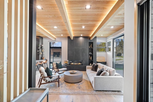living room with wooden ceiling, beamed ceiling, a healthy amount of sunlight, and recessed lighting
