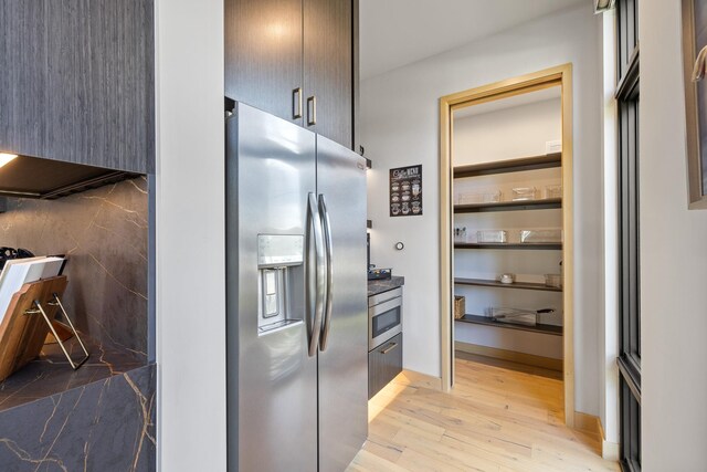kitchen with stainless steel refrigerator with ice dispenser and light wood-type flooring