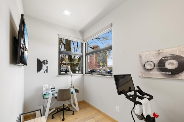 office space with wood finished floors and baseboards