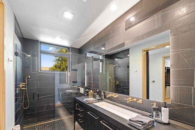 full bath featuring vanity, a shower stall, and tile walls