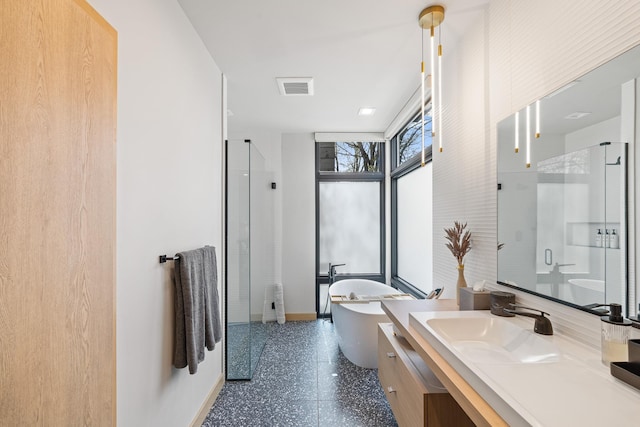 full bath with visible vents, a stall shower, baseboards, a freestanding tub, and vanity