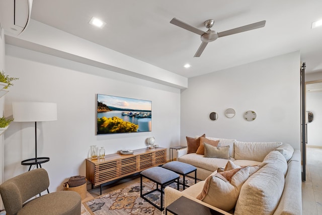 living room with recessed lighting, ceiling fan, and light wood-style flooring