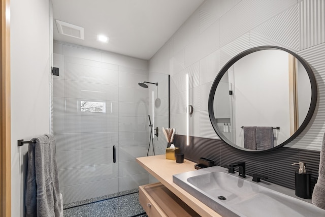 bathroom featuring visible vents, vanity, and a stall shower