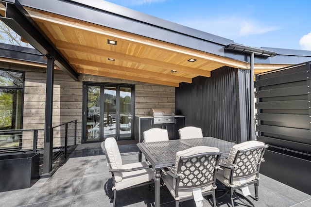 view of patio / terrace with area for grilling, outdoor dining space, and french doors