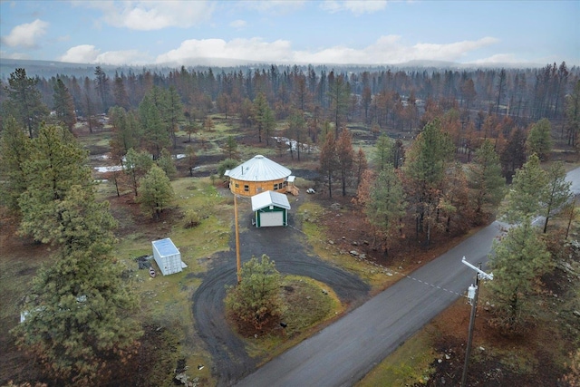 birds eye view of property with a wooded view