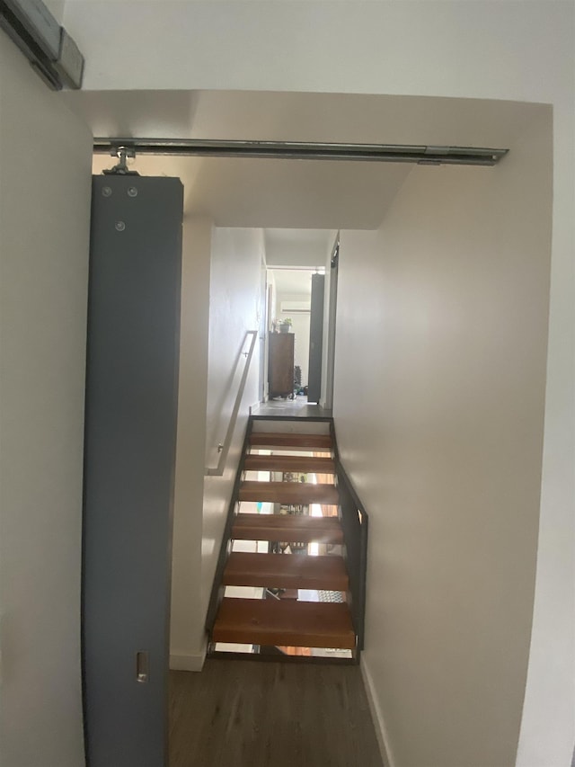 stairs with baseboards and wood finished floors