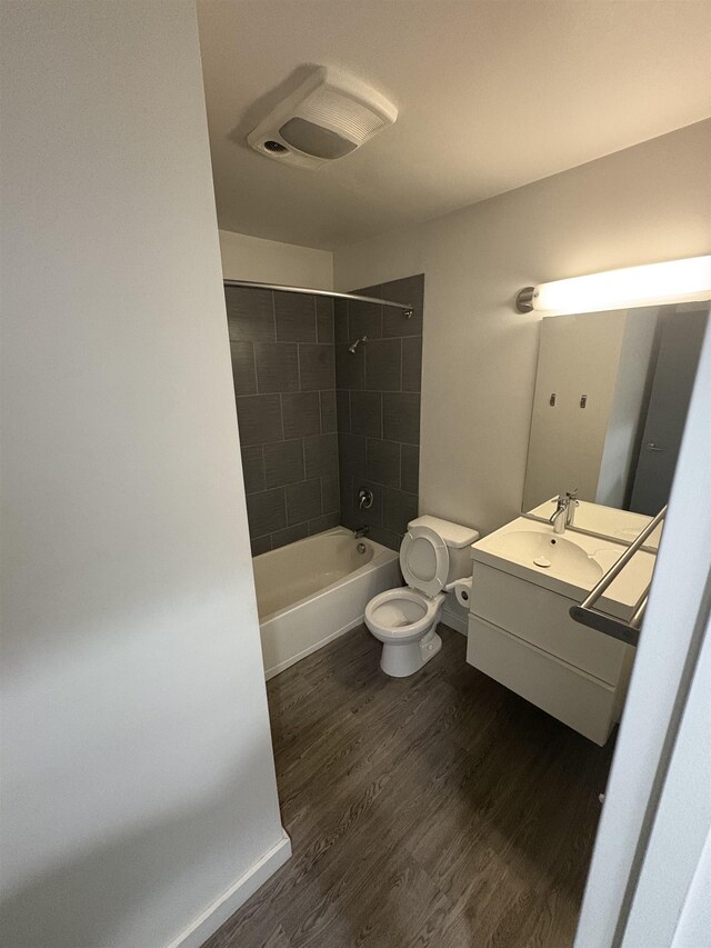 904 E Indiana Ave, Spokane, WA 99207 - full bath featuring vanity, wood finished floors, and washtub / shower combination