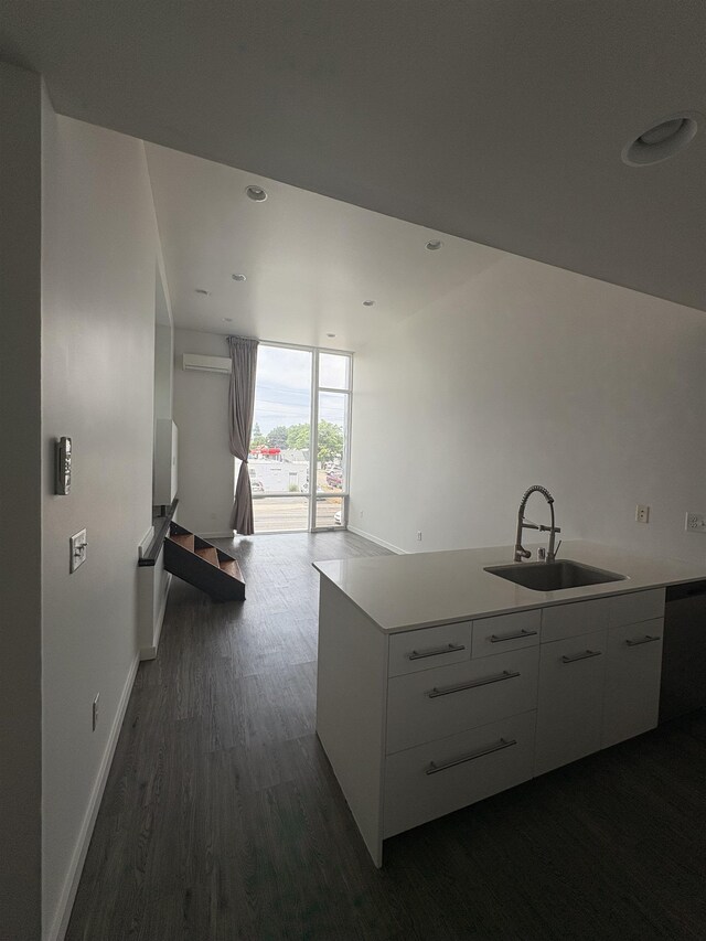 904 E Indiana Ave, Spokane, WA 99207 - kitchen with dishwasher, dark wood-style flooring, modern cabinets, light countertops, and white cabinetry