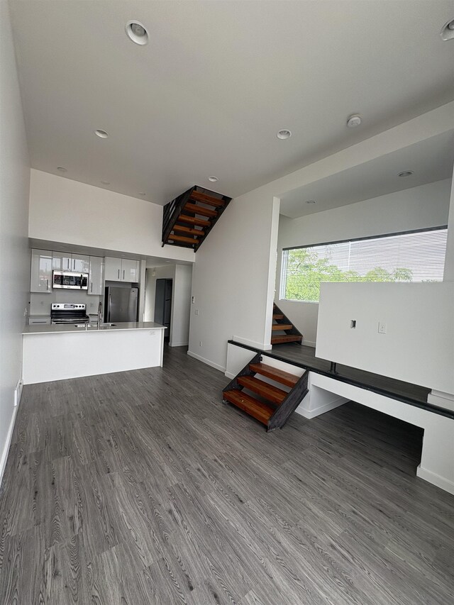904 E Indiana Ave, Spokane, WA 99207 - unfurnished living room with dark wood finished floors and recessed lighting