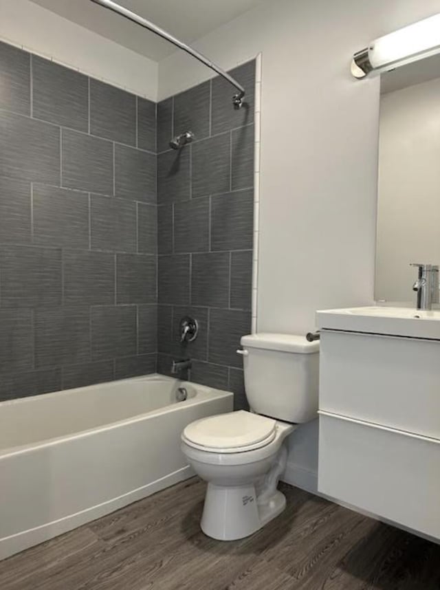 full bath featuring vanity, toilet, wood finished floors, and shower / bathing tub combination