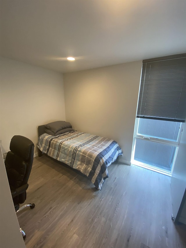 bedroom with recessed lighting and wood finished floors