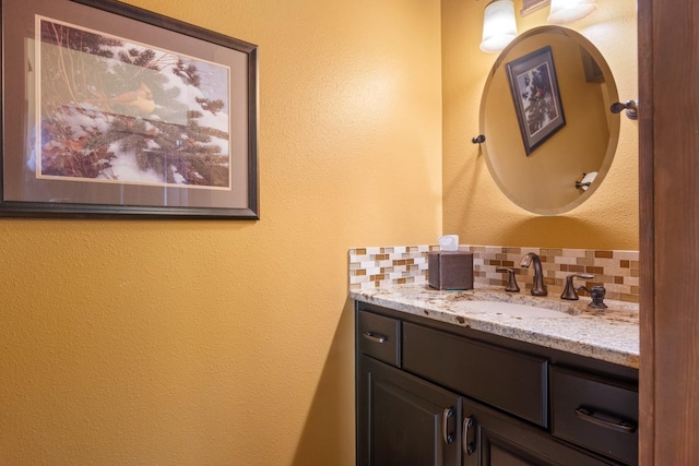 bathroom featuring vanity and a textured wall