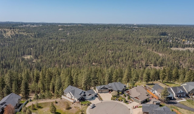 birds eye view of property featuring a forest view and a residential view